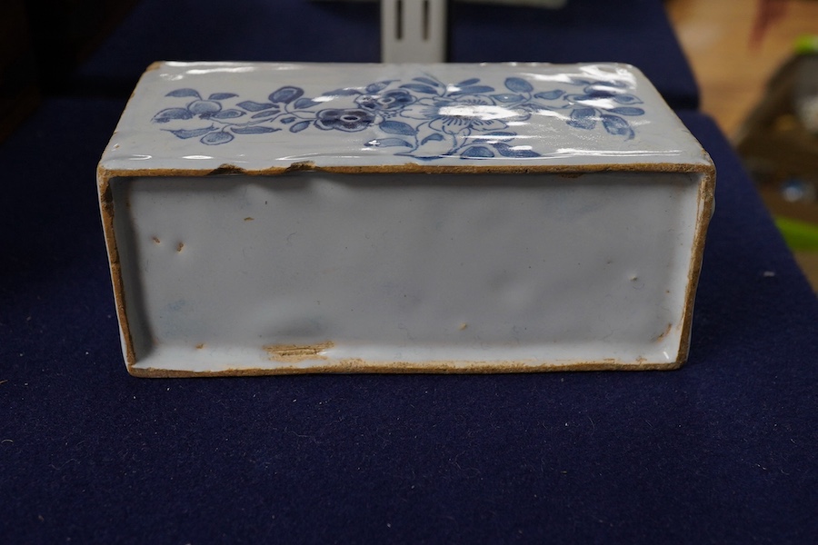 An 18th century English delftware flower brick, 15cm wide, 8cm high. Condition - edges chipped and larger chip to one corner, usual for pottery type, use and age